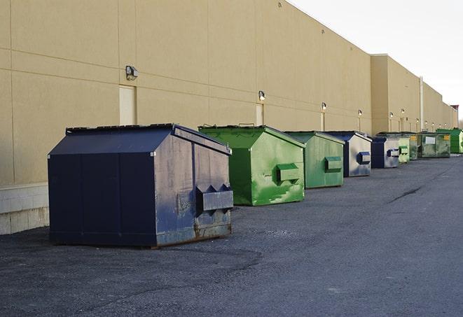 a crowd of dumpsters of all colors and sizes at a construction site in Edison